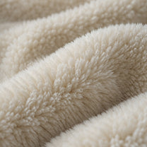 Close-up of the cream coral fleece pile shifting under changing light